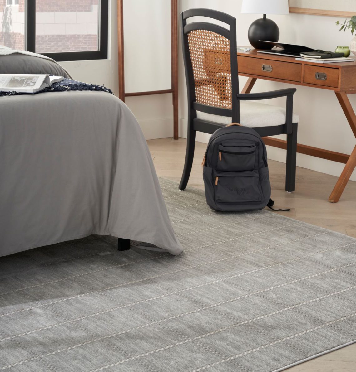 Grey rug in a dorm room