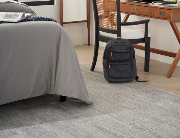 Grey rug in a dorm room