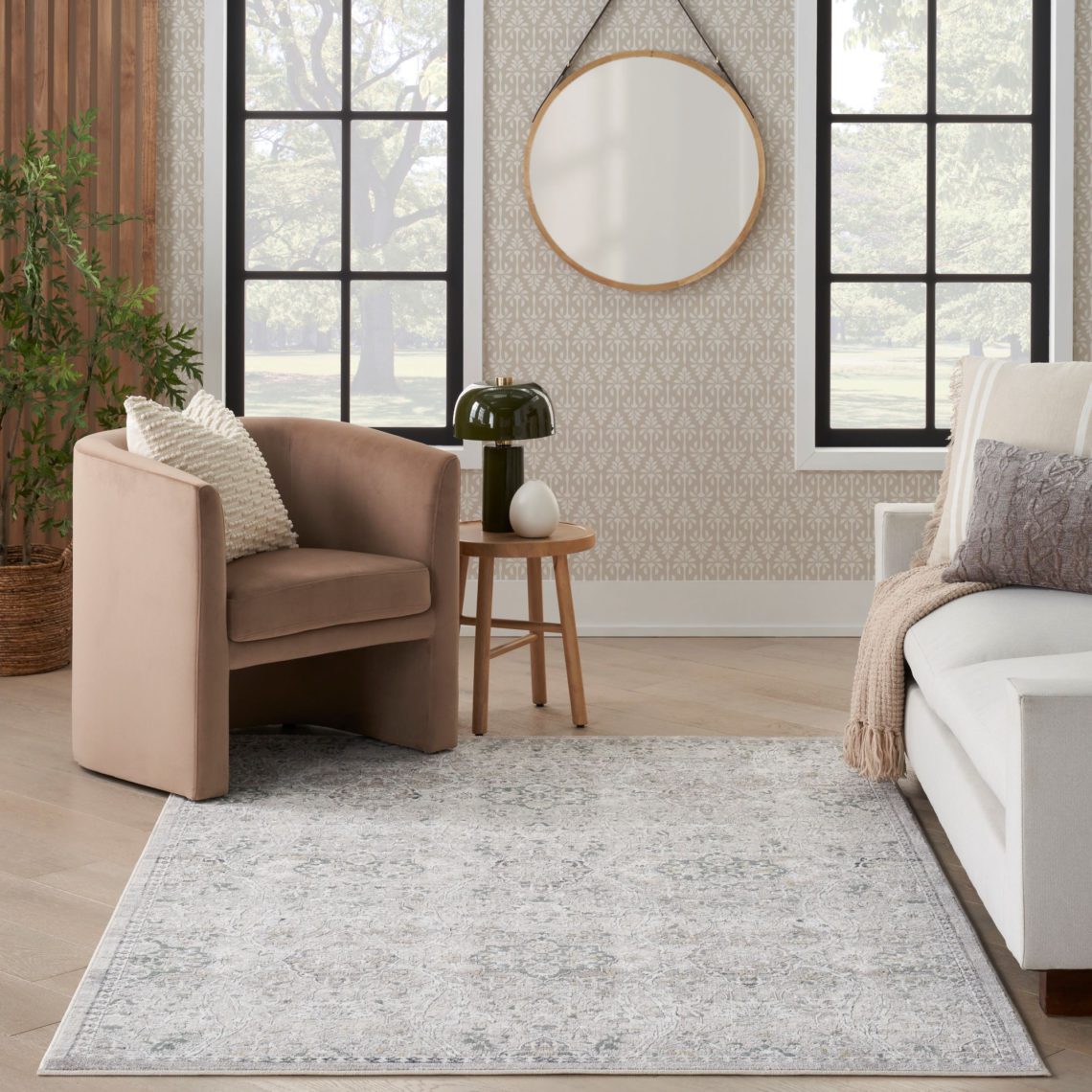 Vintage-style rug in a living room with neutral patterned wallpaper